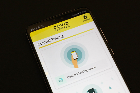 A picture of a smartphone with a COVID-19 tracking app open