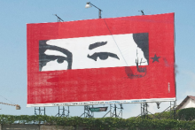 Una valla con los ojos de Hugo Chávez, expresidente de Venezuela. El diseño, representando la mirada vigilante del expresidente, es común a lo largo del país. Photo credit: Wilfredo Rodríguez